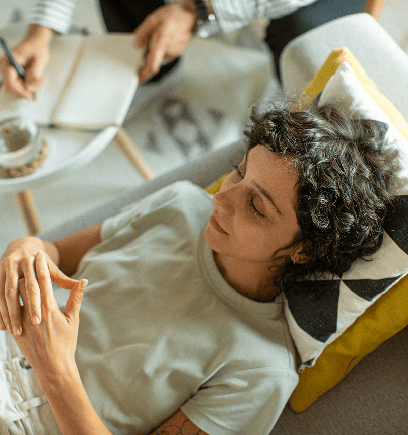 An ethnic woman laying on a couch in counselling