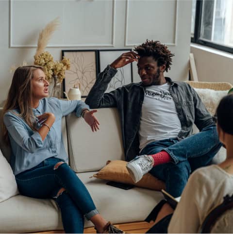 Three people talking in a comfortable room
